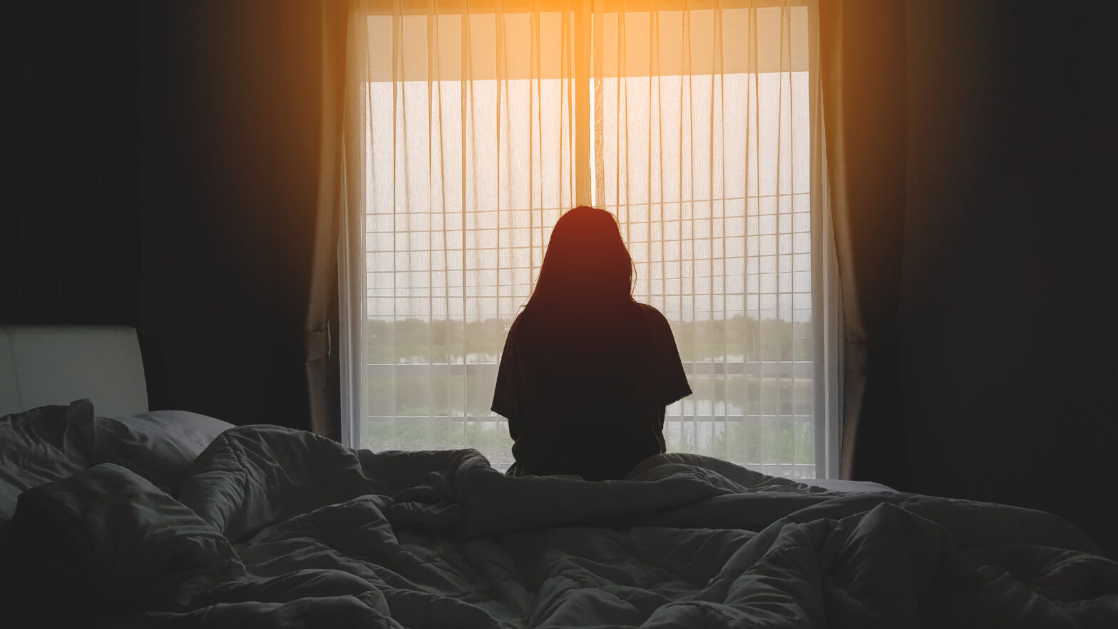 Woman sitting on a bed