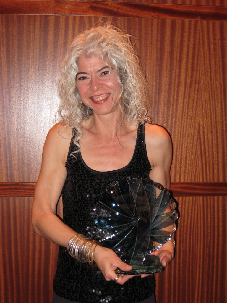 Colleen Coble posing with a trophy